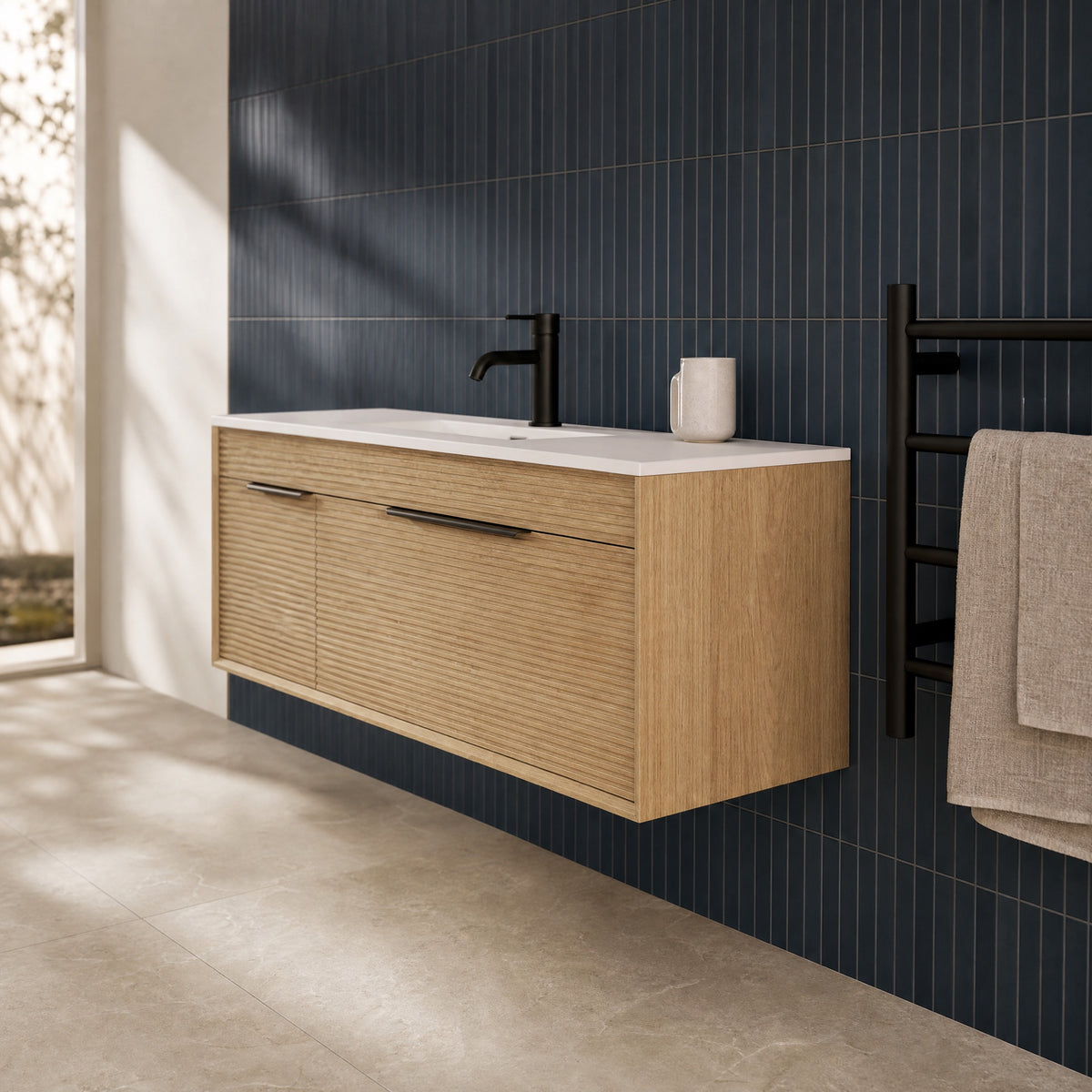 Oak fluted wall hung vanity against a navy tiled wall